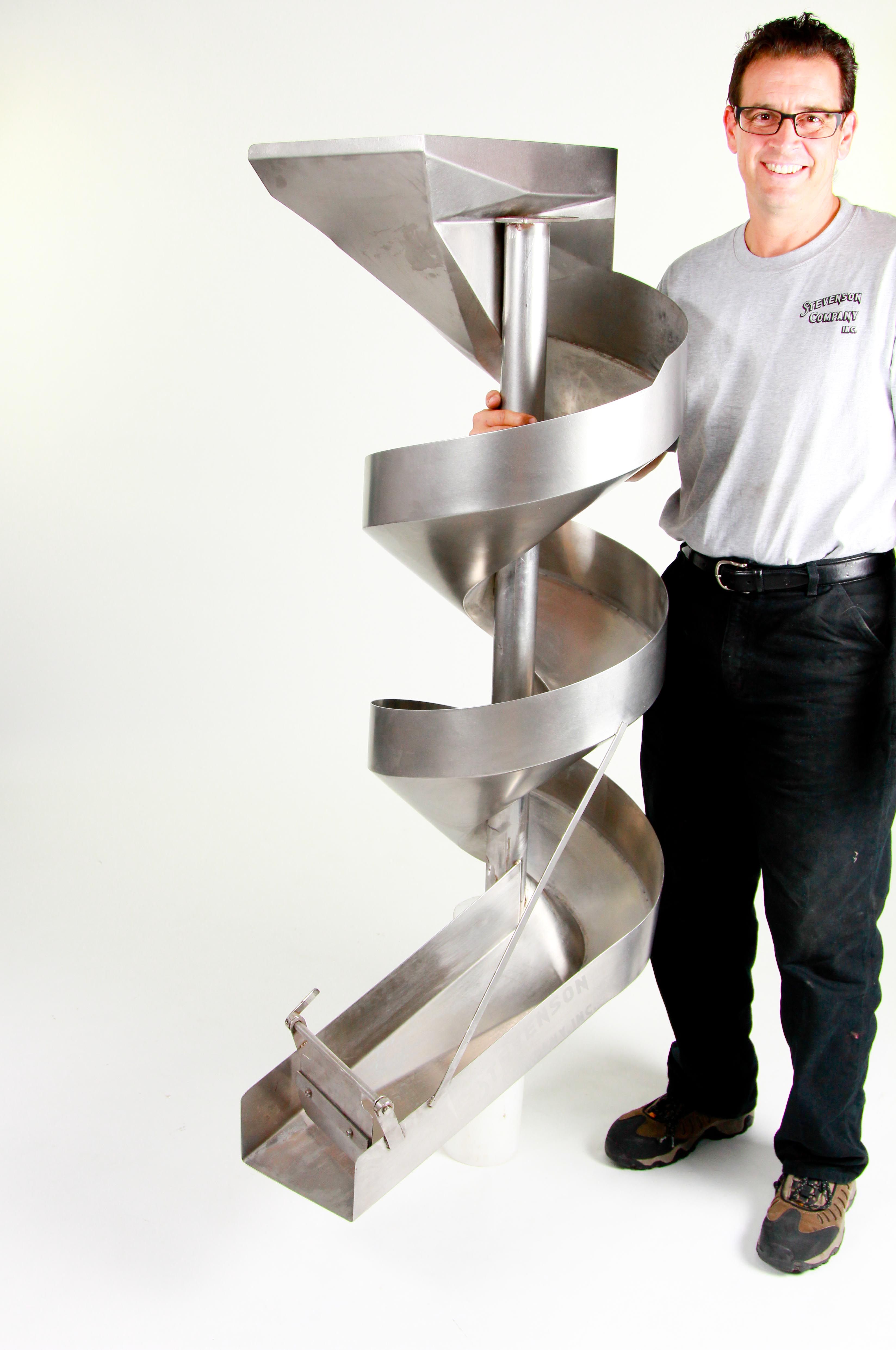 Joe Pennington, President/CEO of Stevenson Company, showing one of their stainless steel spiral chutes